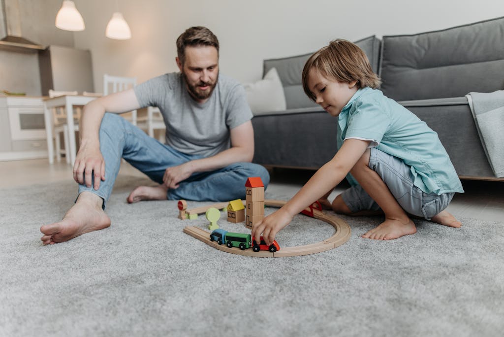 Father Sitting on the Floor and Playing with His Son